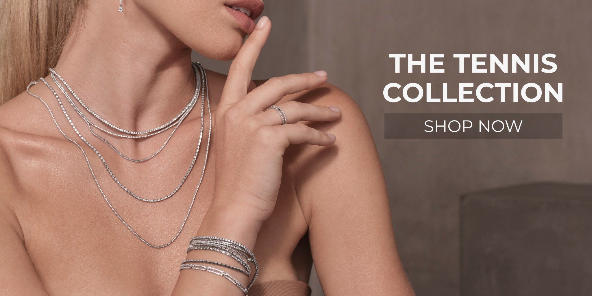 Model showcasing elegant jewelry from the Tennis Collection. Shop now.