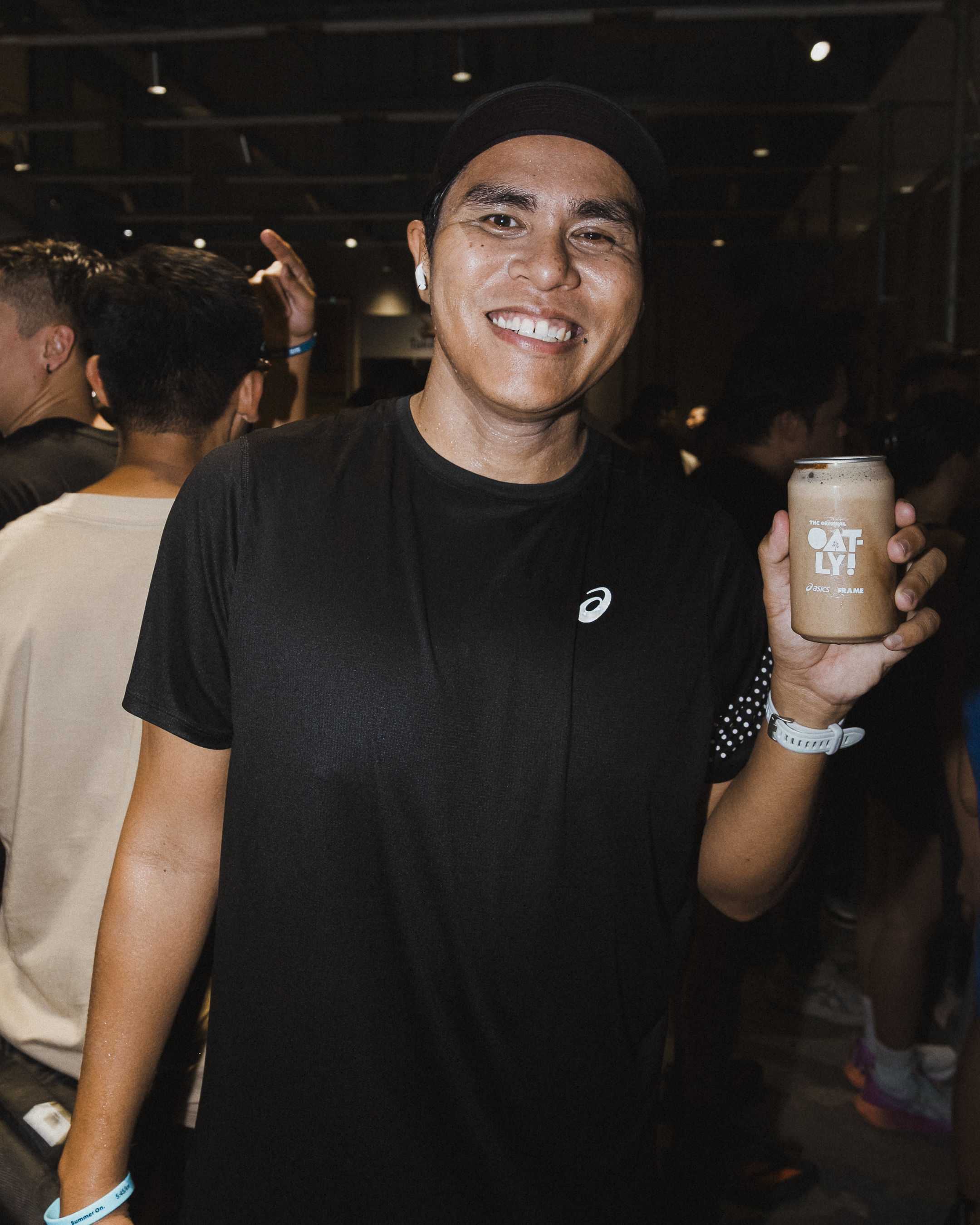 Runners enjoying Oatly recovery drinks after the Global Running Day community run with ASICS and FRAME RUN CLUB in Dubai Design District.