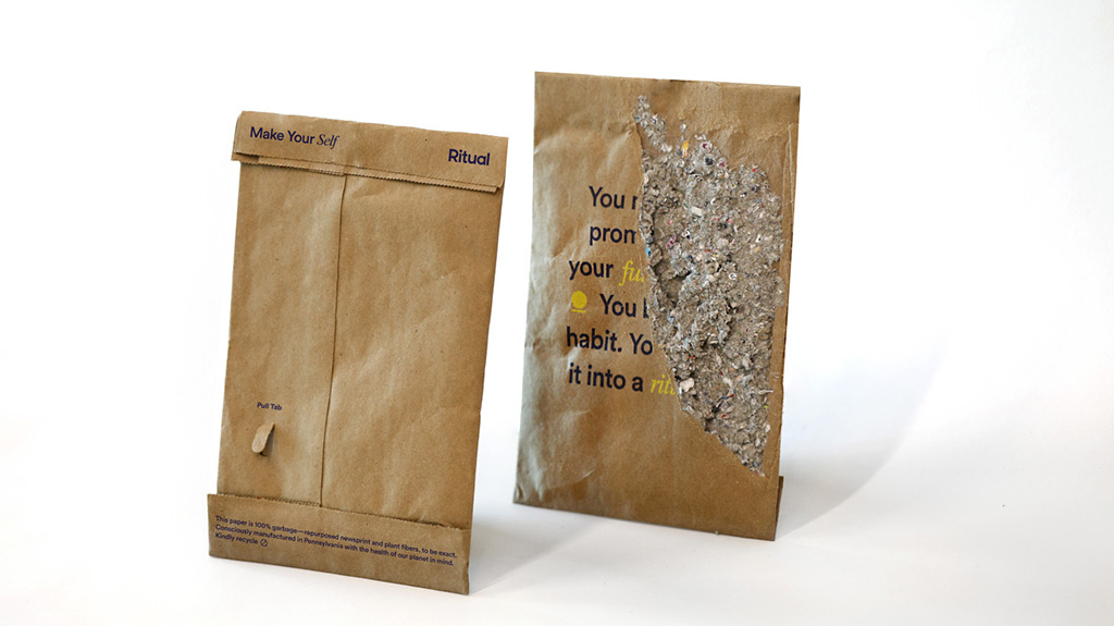 Two kraft mailers with one containing pulps of paper.