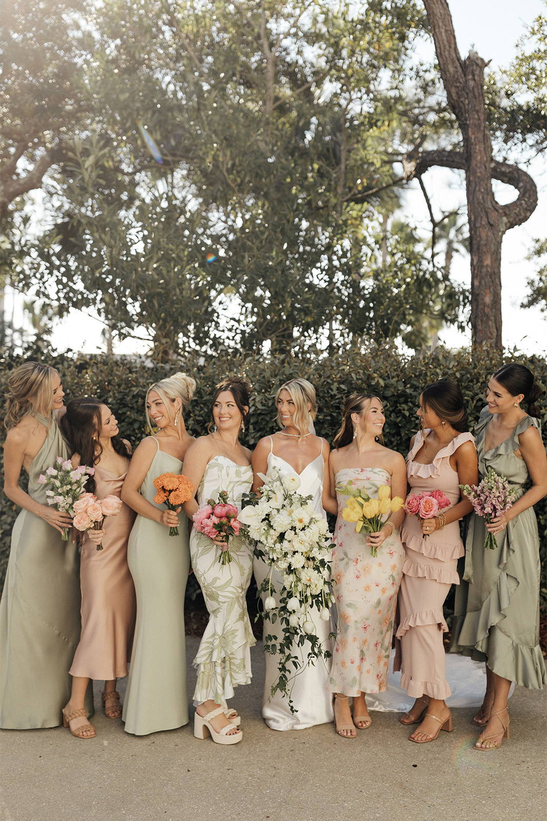 Bride and her bridesmaids smiling next to each other