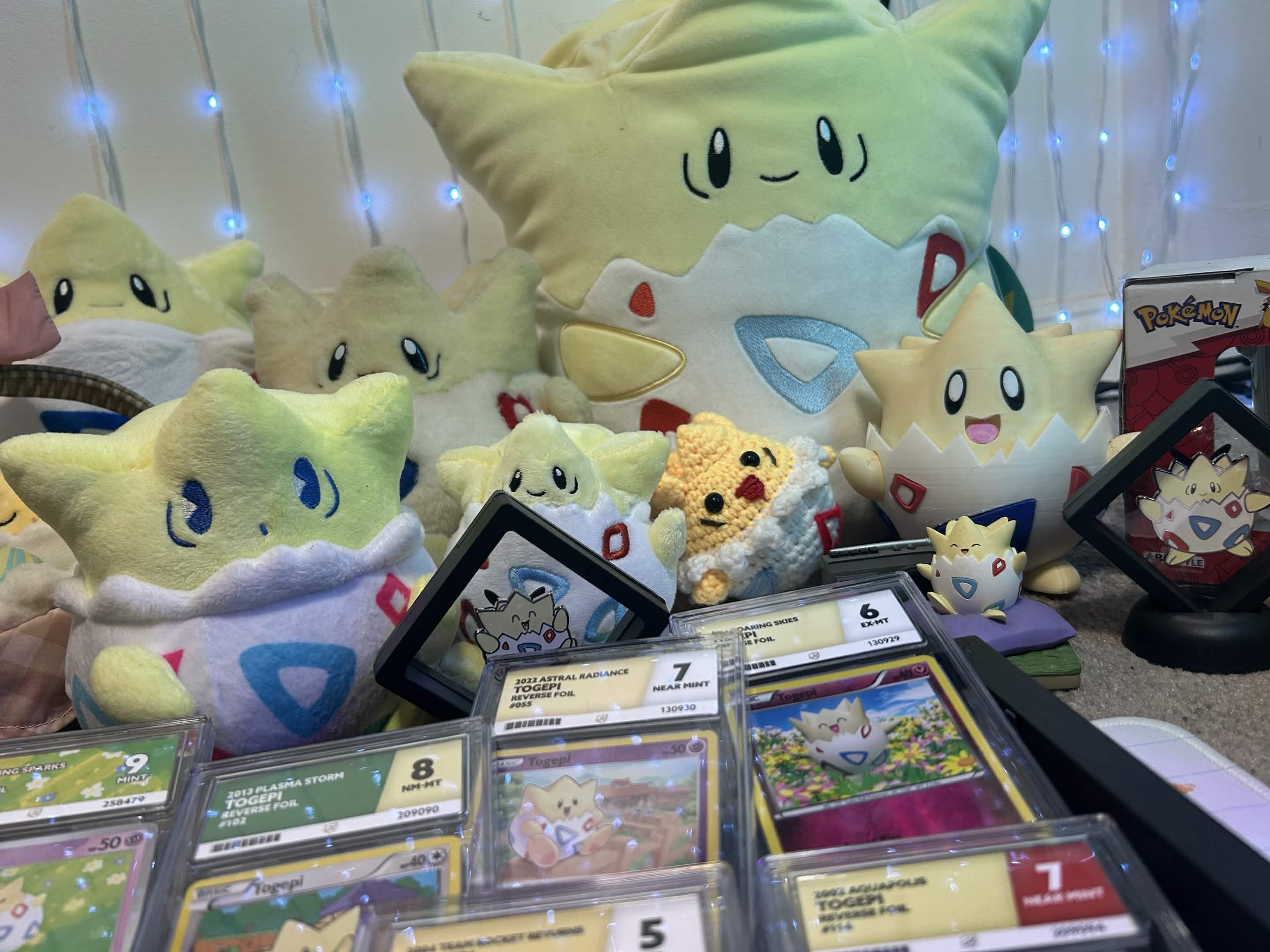 A collection of Pokémon plush toys and trading cards on a table.