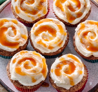 Almond Churro Cupcakes on a serving platter - – see more on our Instagram