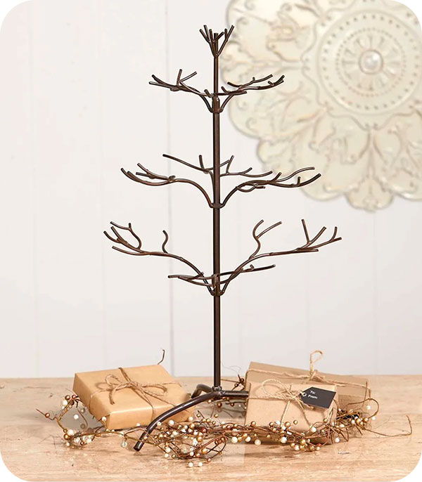 Decorative tree with branches, surrounded by gifts and festive decorations.