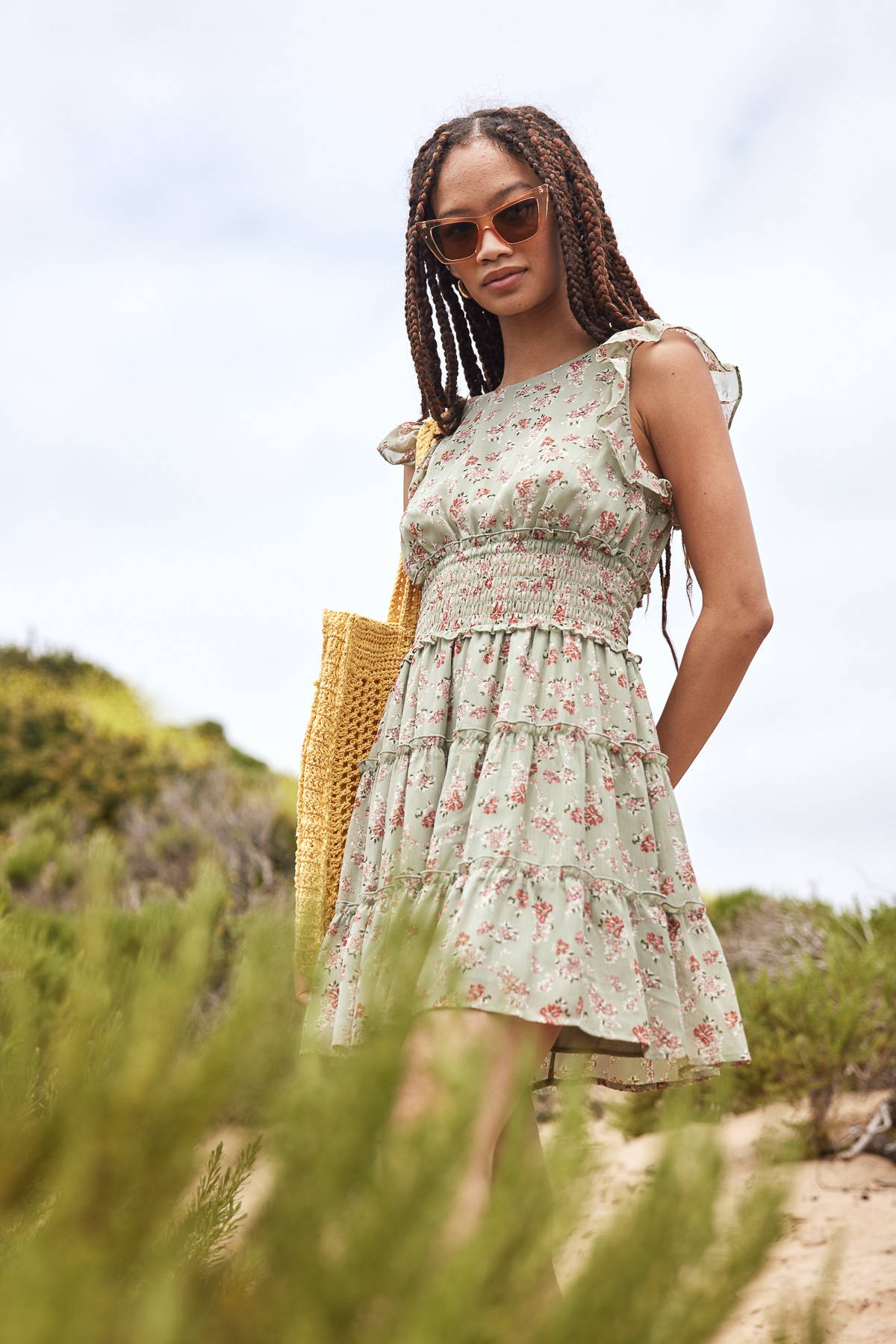 Trixxi sun-kissed summer, girl at beach in sage floral mini dress.