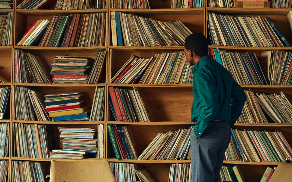 Person looking at a large collection of records on shelves.