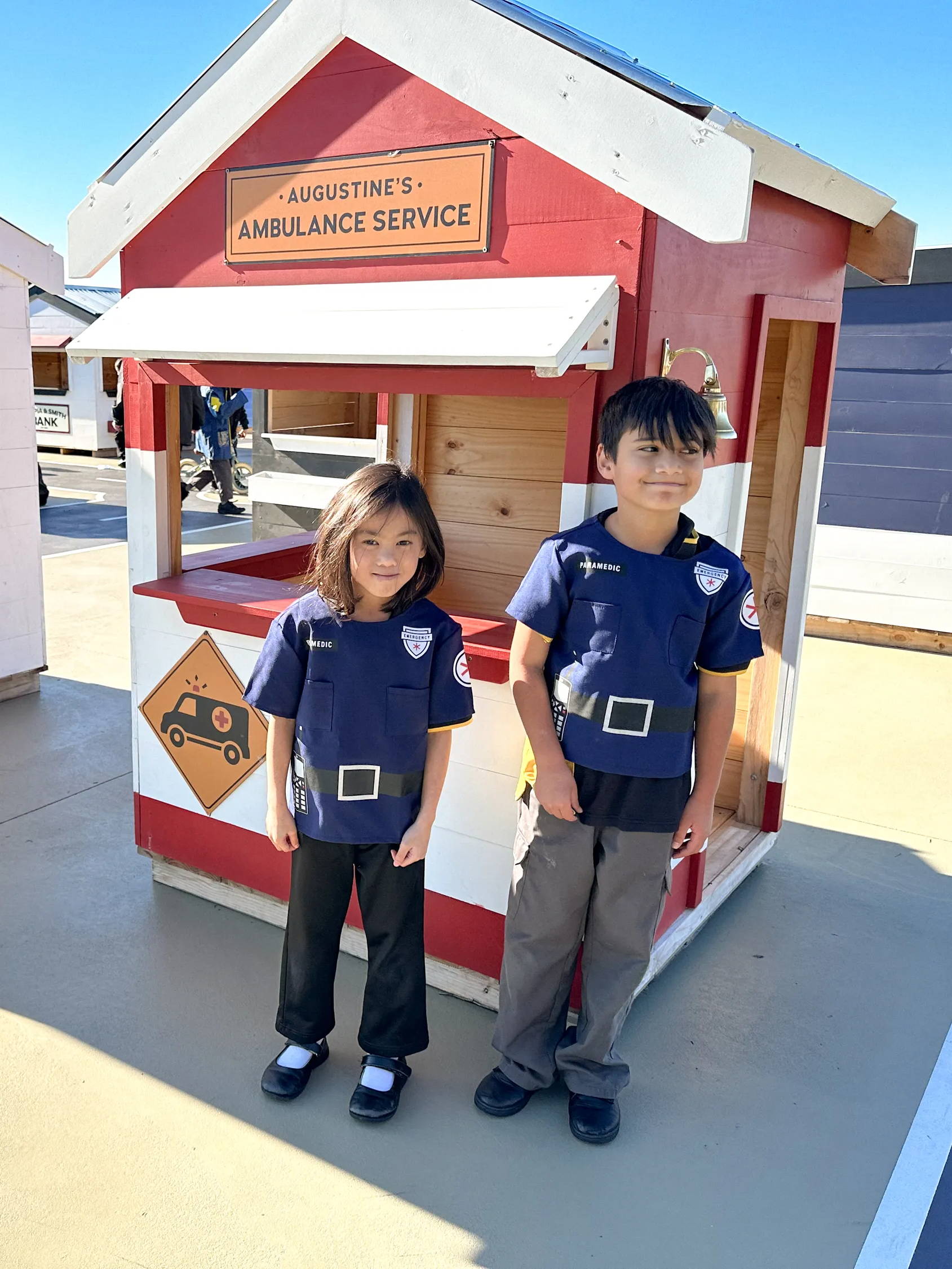 Kids pretending to be Ambulance Workers playing in their wooden cubby house