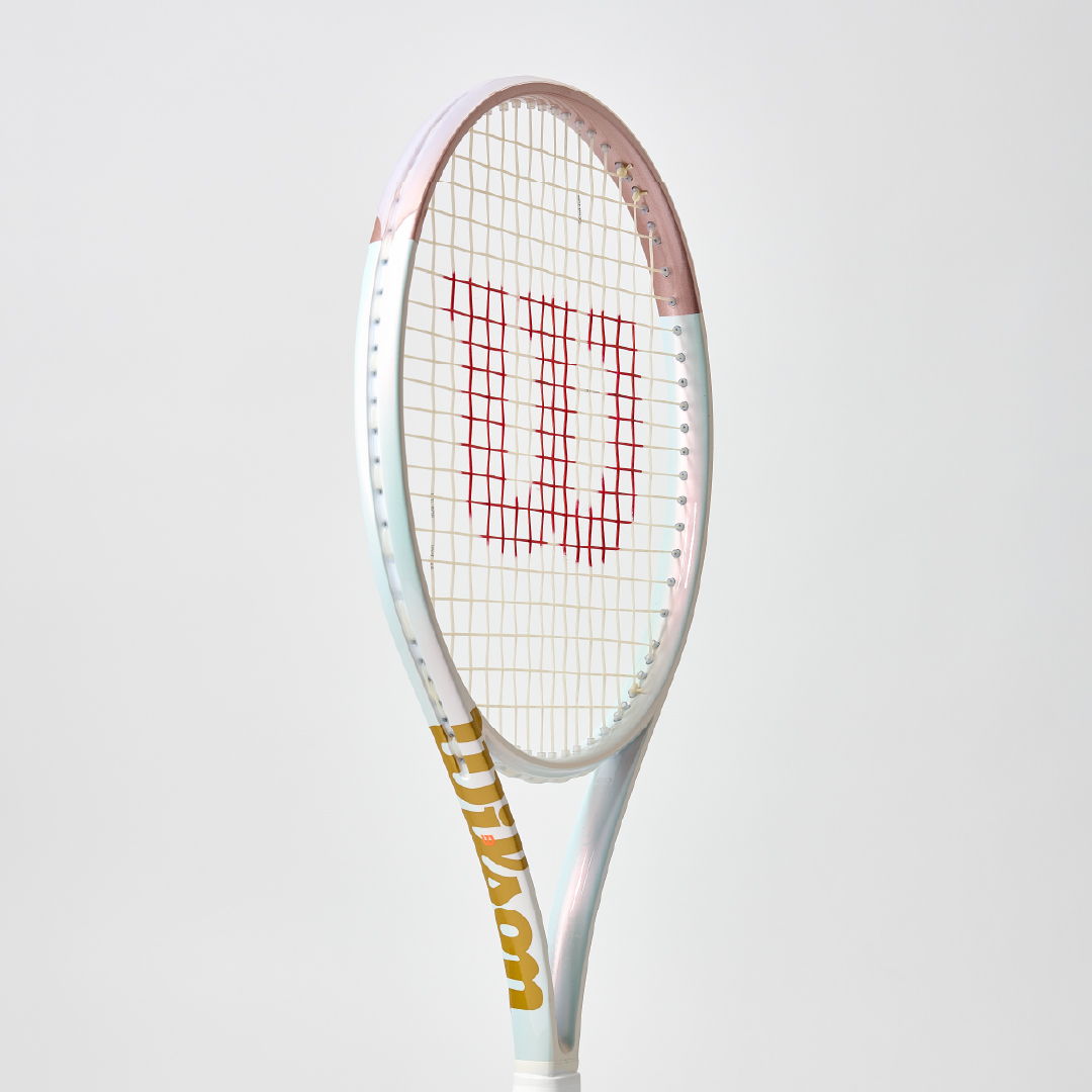 A tennis racket with a Wilson logo against a plain background.