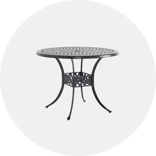 Round metal table with intricate design and curved legs.