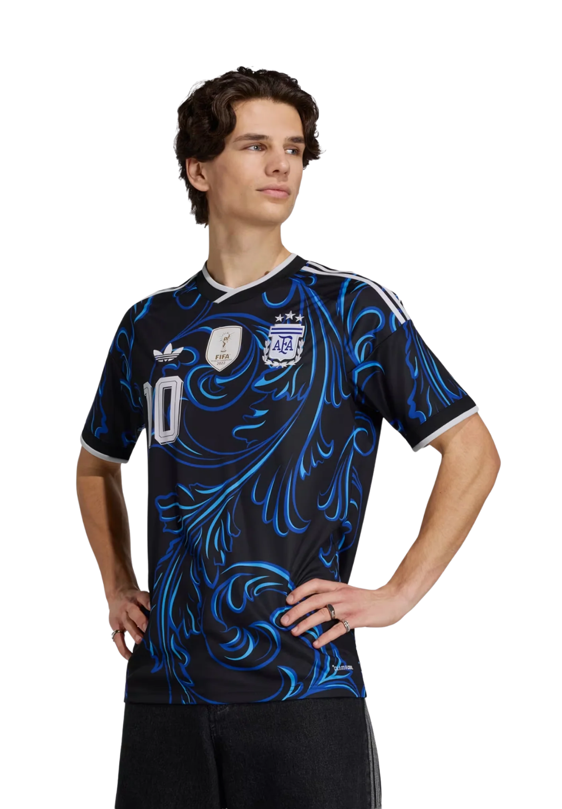 Young man wearing a black jersey with blue floral designs, posing confidently.