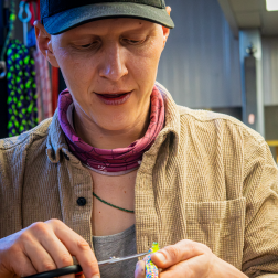 Person working on a craft project, focused on their task.