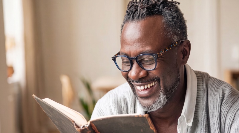 man wearing Dare Navy reading glasses while reading