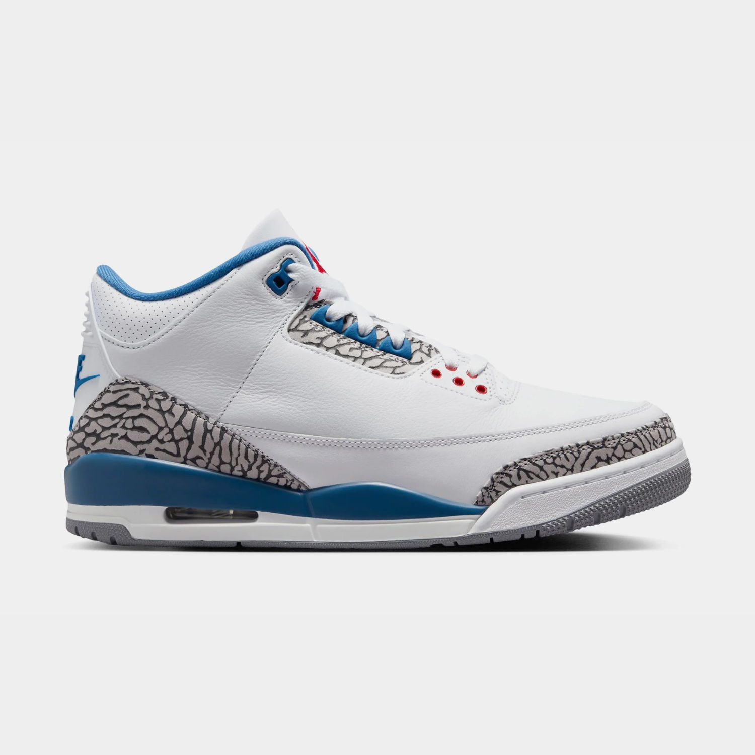 White and blue sneaker with elephant print accents.