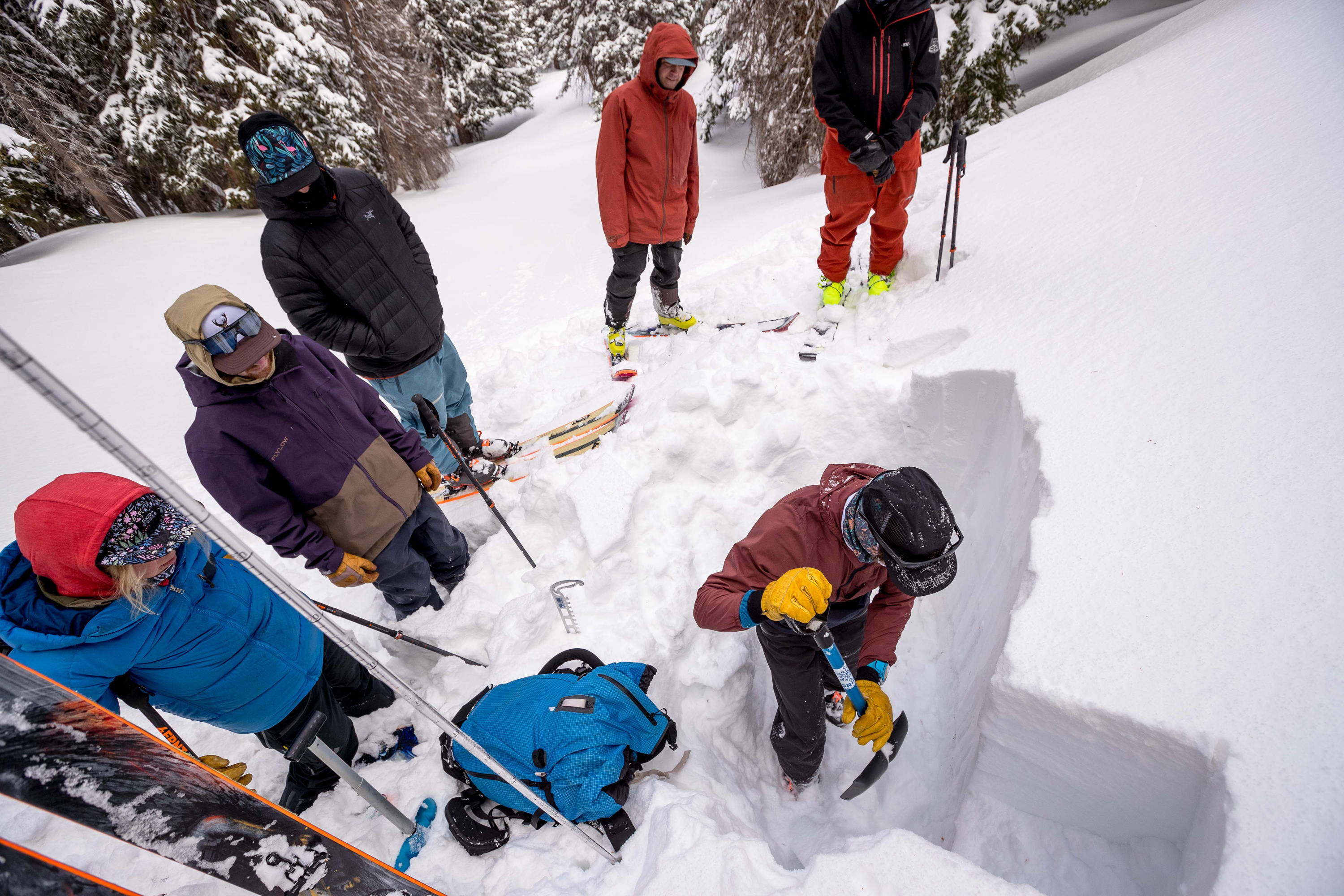 group of skiers digging snow