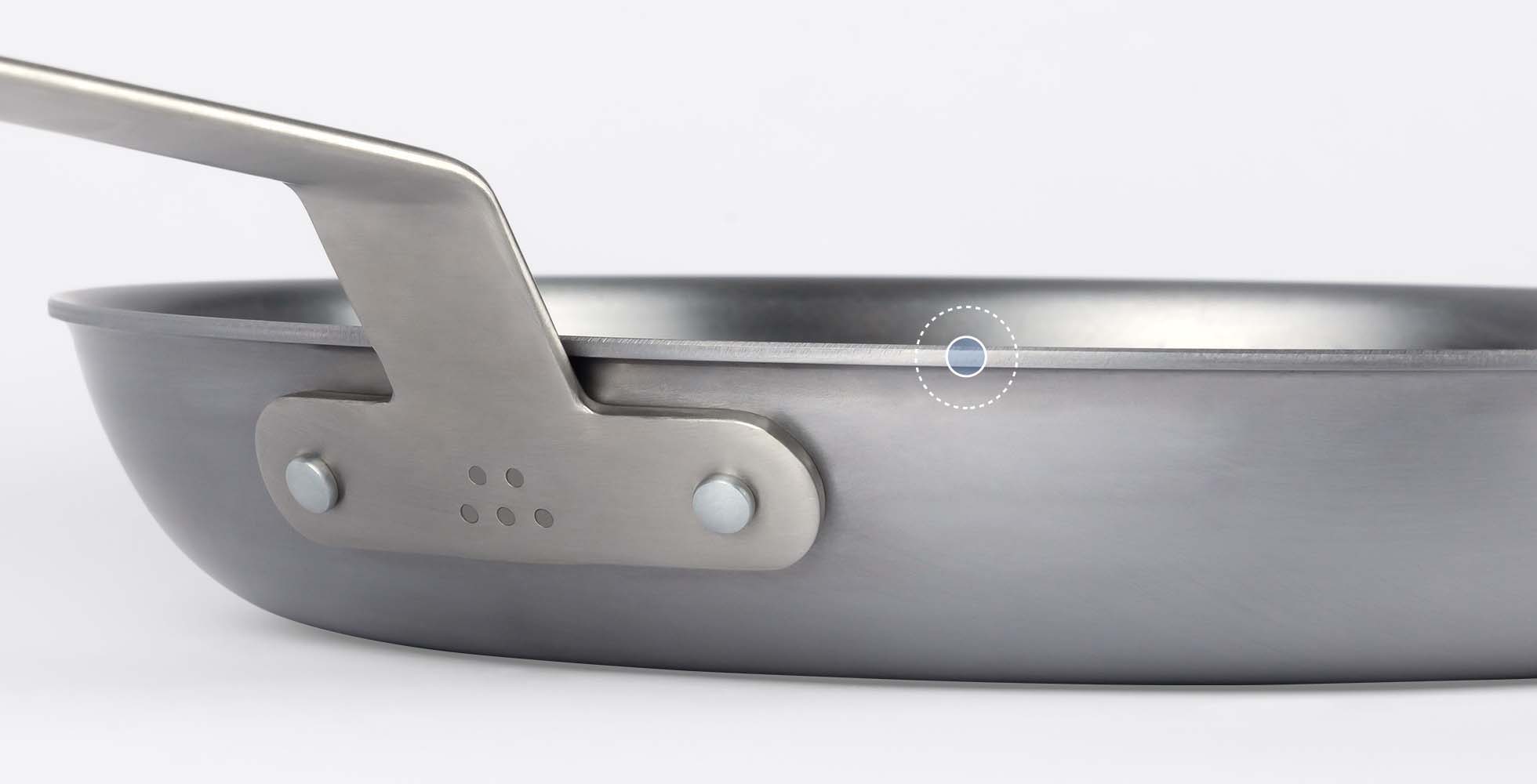 A Misen Carbon Steel Pan seen from the side, with its optimal side wall height indicated by a blue dot.