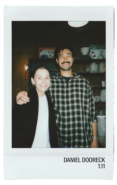 Two people smiling together in a cozy indoor setting.