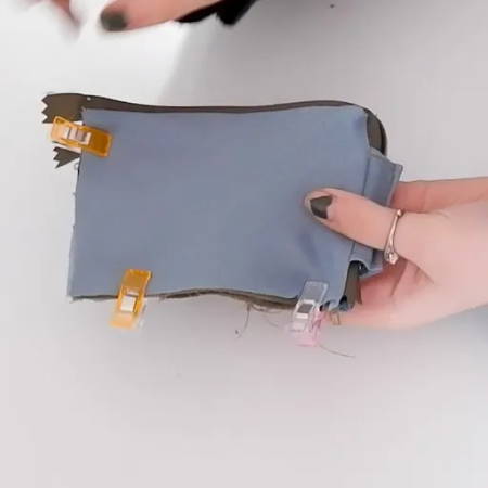 using sewing clips to hold fabric layers together when sewing a mini zipper wallet