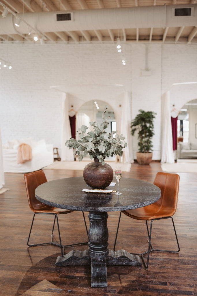 Leather seats at a round table inside the Chicago Grace Loves Laces bridal shop