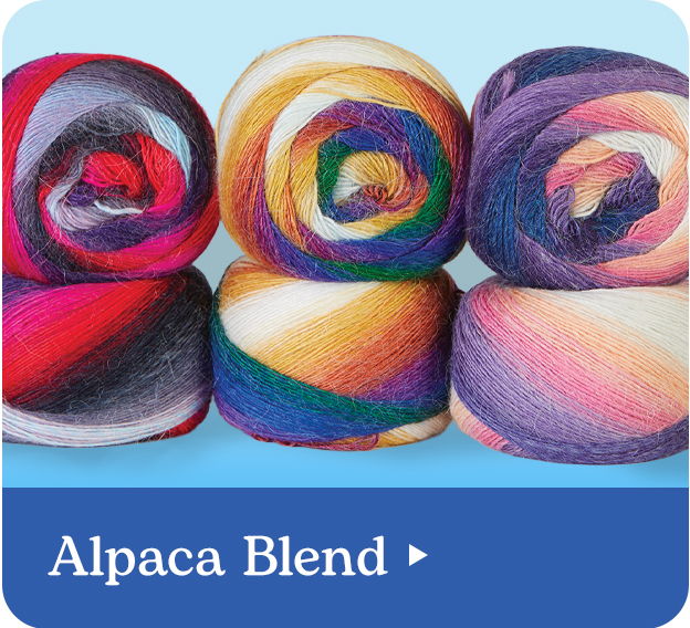 Colorful rolls of alpaca blend yarn on a blue background.