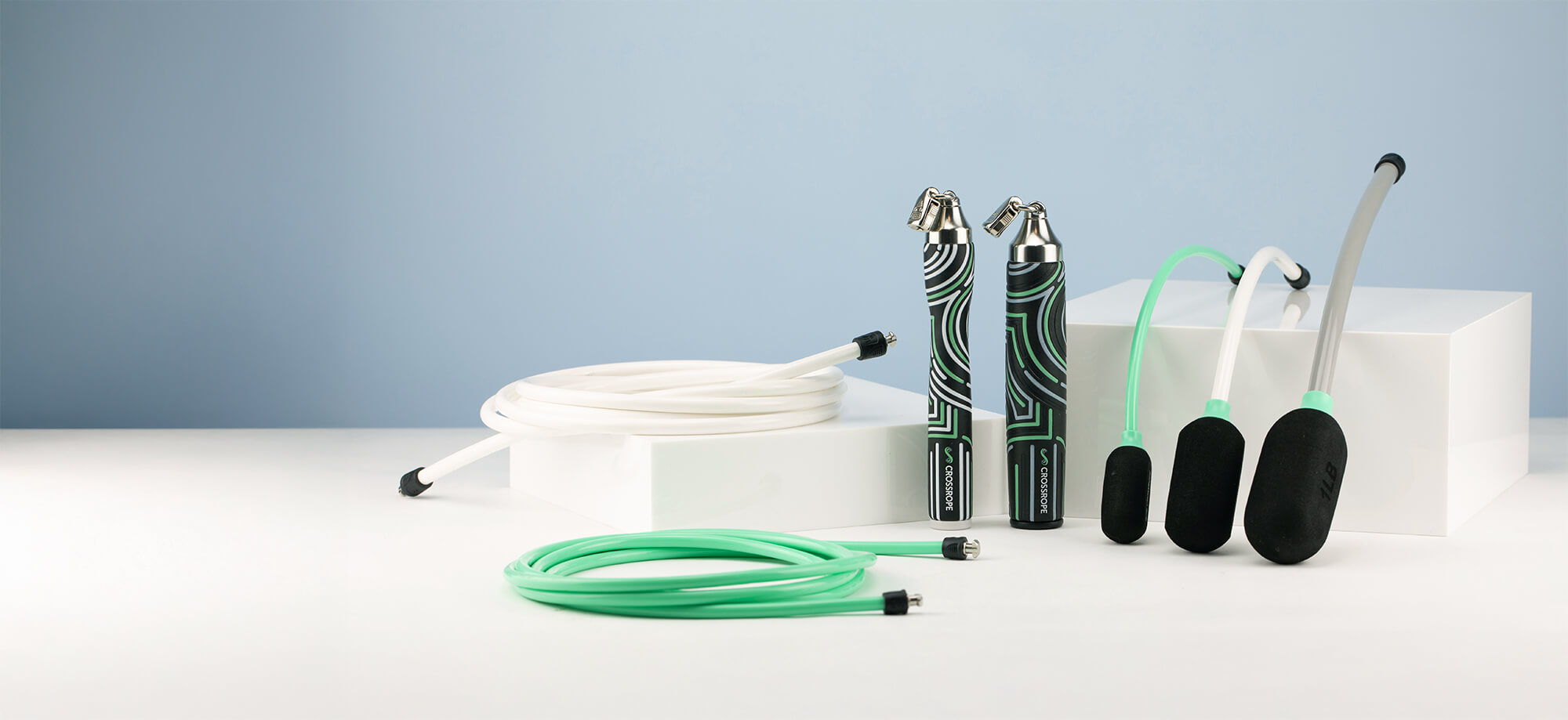Various jump ropes on a white surface.
