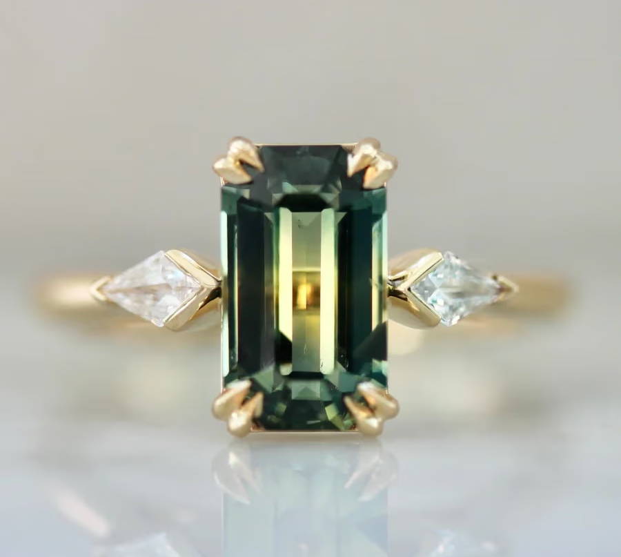 Emerald cut green sapphire ring with kite cut diamond side stones