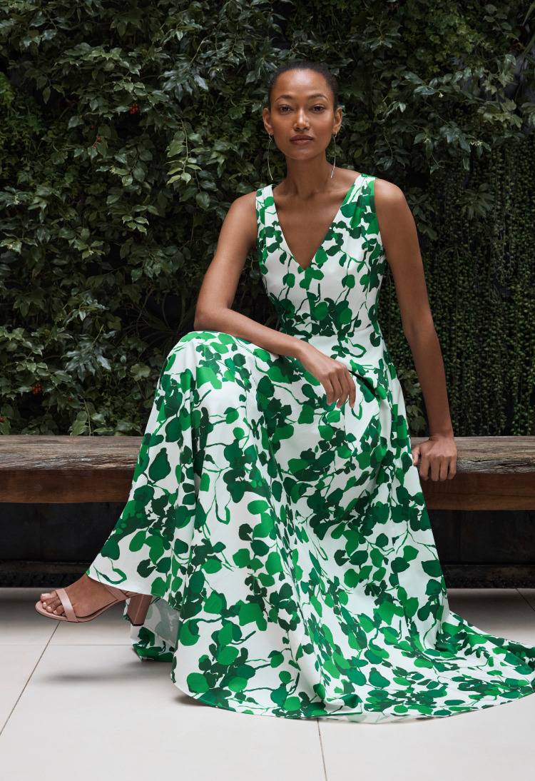 Model wearing ivory and green Almeria maxi dress