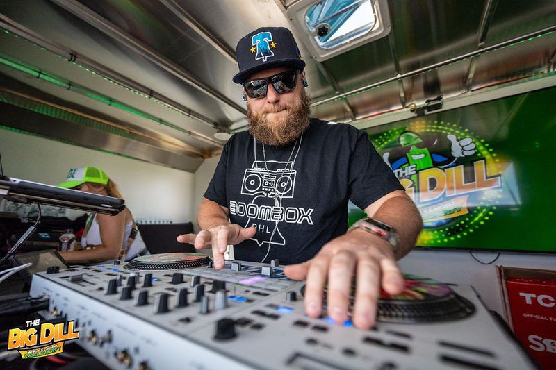 Philly DJ in a Boombox PHL shirt spinning in The Big Dill® Airstream DJ booth, bringing Pickle RAVE energy to The Big Dill Philadelphia pickle party at Stateside Live! on National Pickle Day