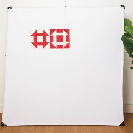 Design wall with two quilt blocks on it