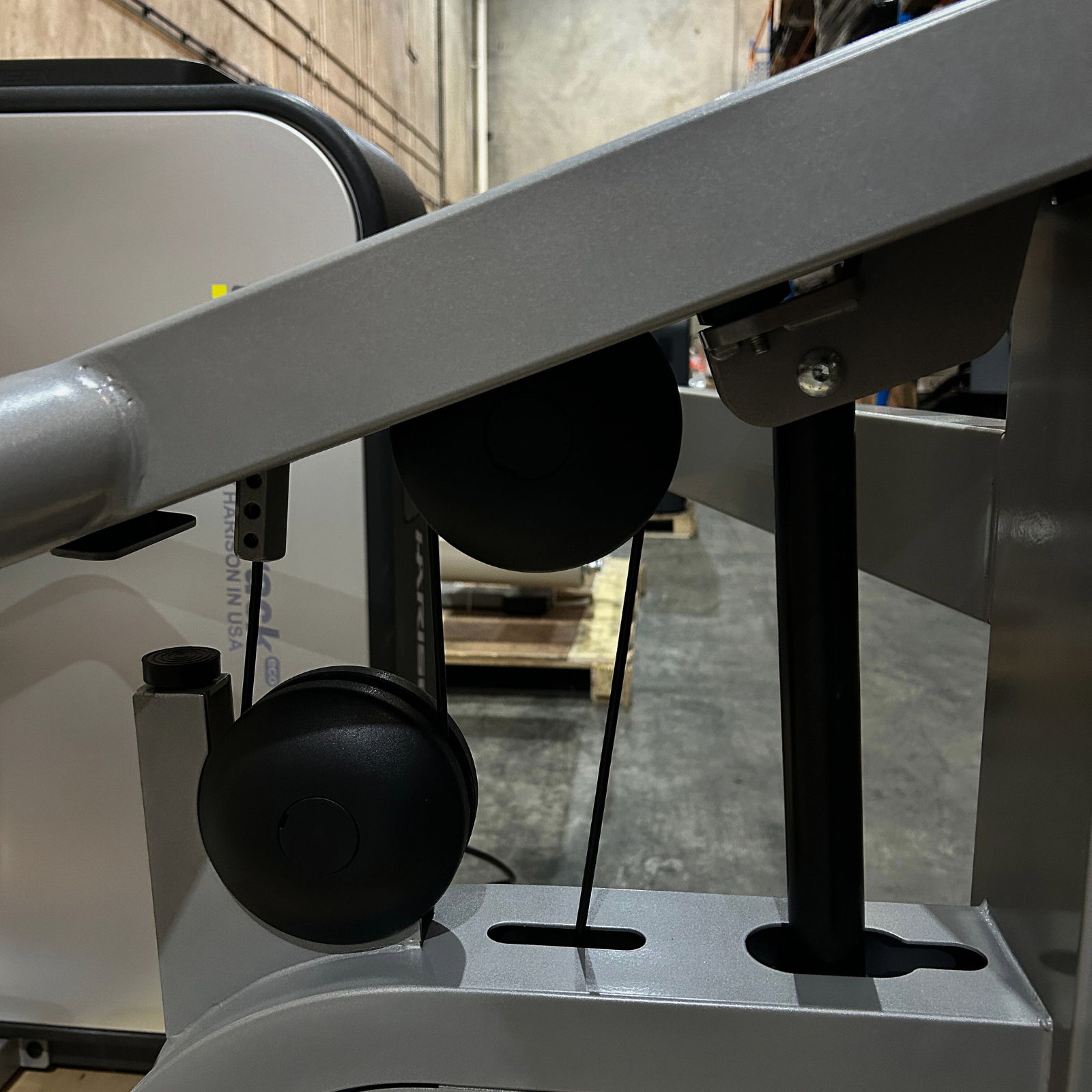 Close-up of gym equipment with weights and cables.
