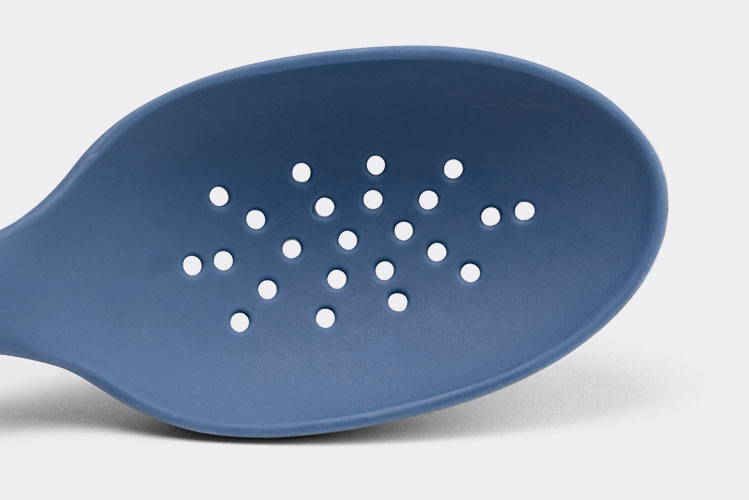 A close view from the front of a Blue Misen Slotted Spoon’s head with drainage holes.