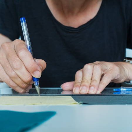 Using a blue heat erasable fabric marker to mark on fabric with a ruler