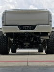 Rear undercarriage lifted white John's 2014 Dodge Ram 2500 chrome exhaust tip off-road tires Shocker XL Train HornBlasters featured customer install gallery photo 4