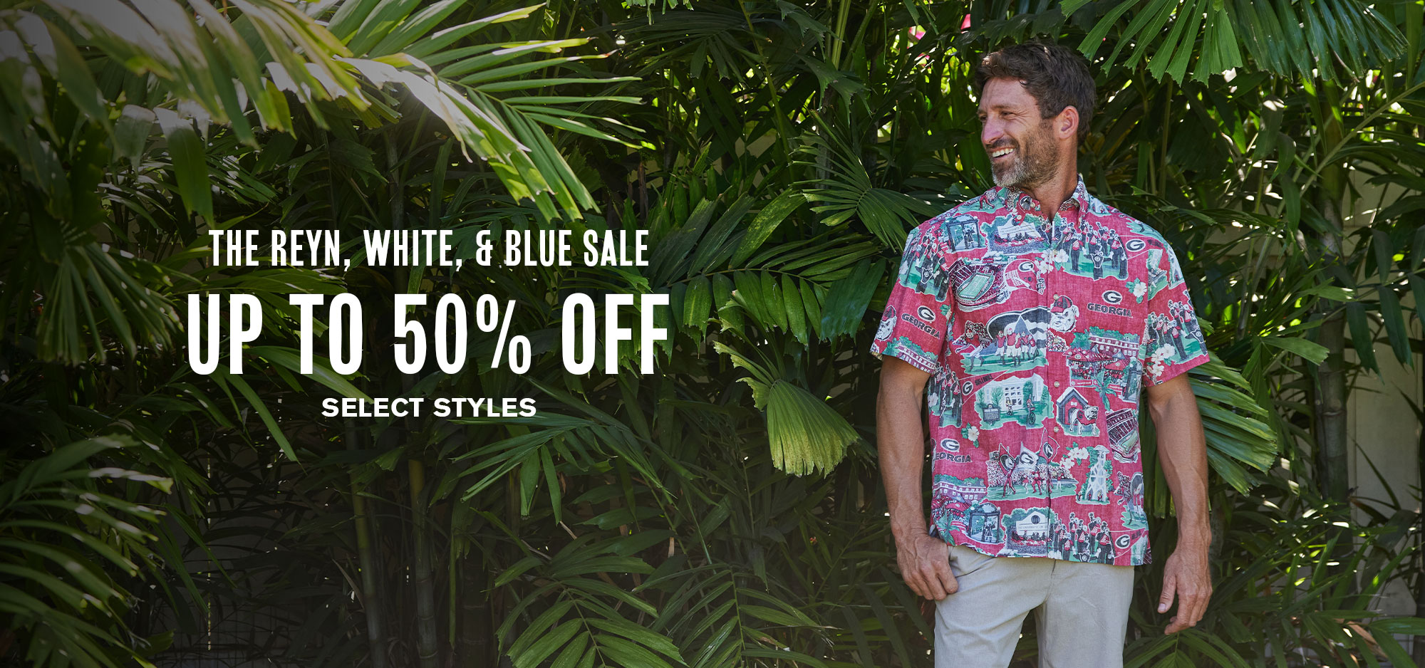 Man in colorful shirt promoting a sale with tropical background.