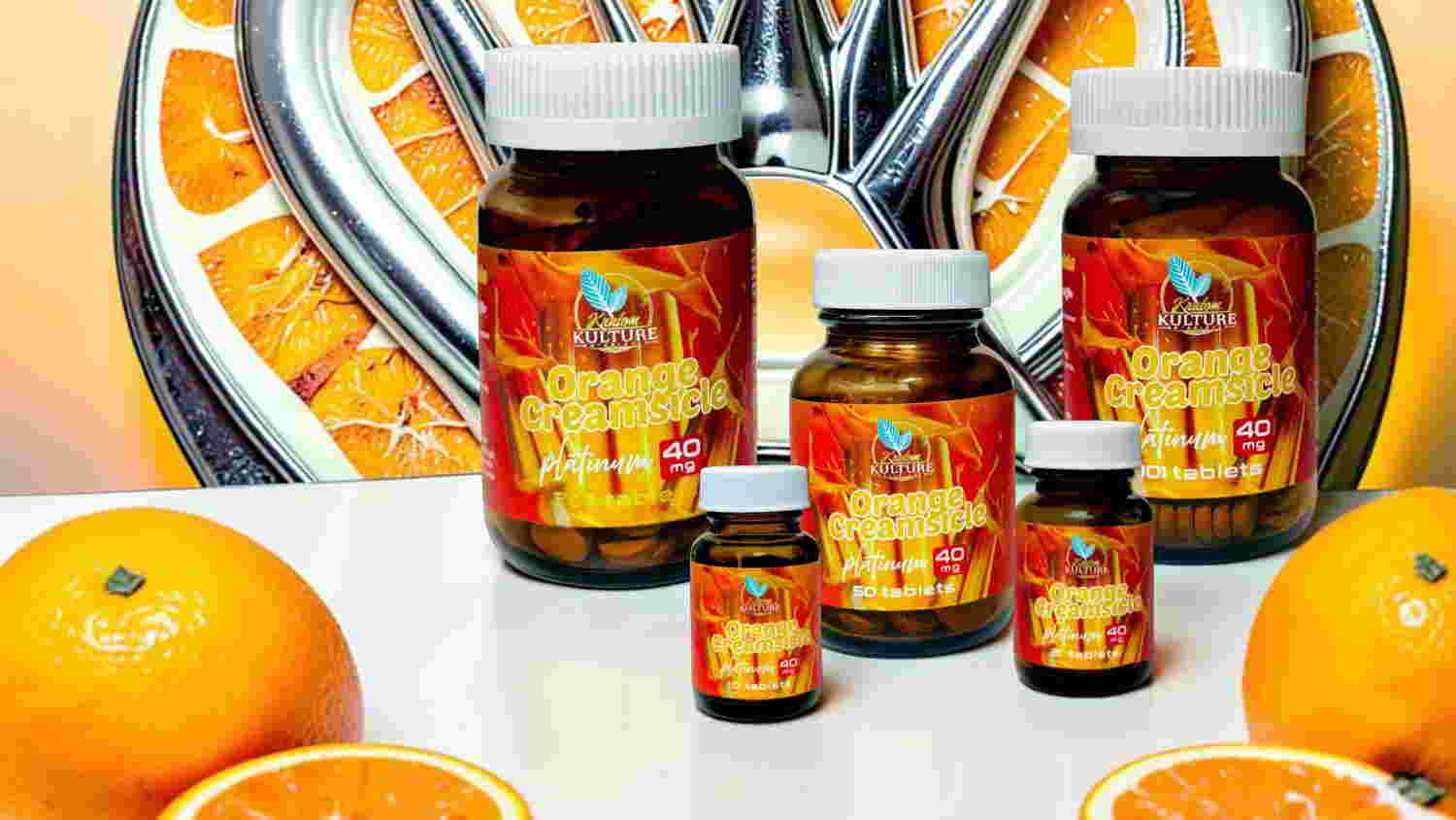 Bottles of vitamin supplements with oranges in the background.