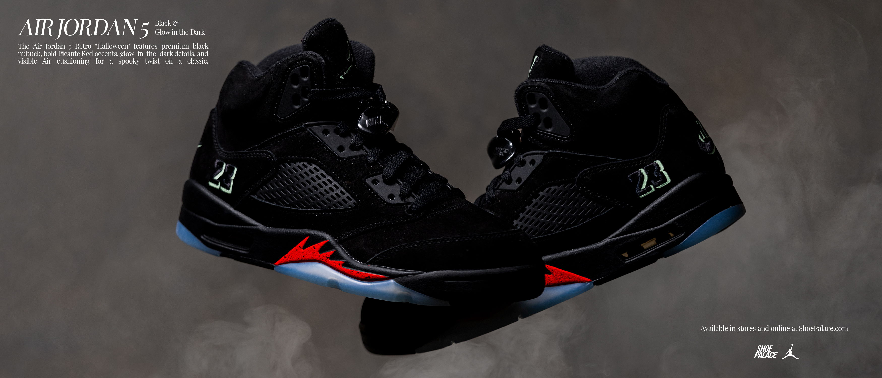 A pair of black and red Air Jordan sneakers on a dark background.