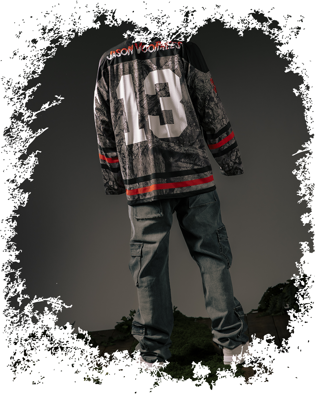 Person wearing a patterned jersey and jeans, viewed from behind.