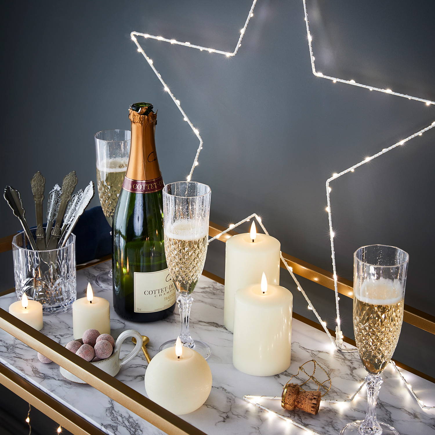 A drinks station with LED candles and star lights.