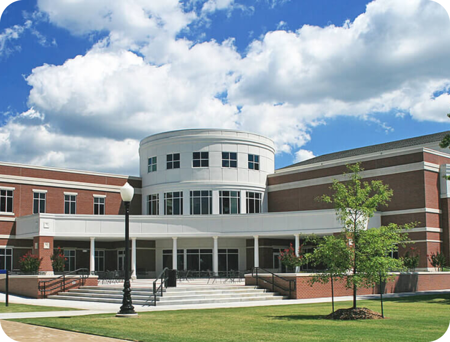 Modern building with a round entrance and blue sky background.