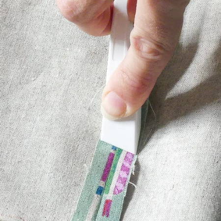 Pressing a seam flat with a finger presser