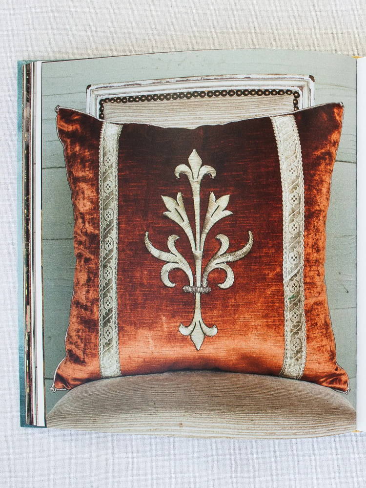 Classic B. Viz Design - raised silver metallic European fleur-de-lys embroidery bordered with antique silver metallic galon on persimmon velvet, pictured in Once Upon A Pillow