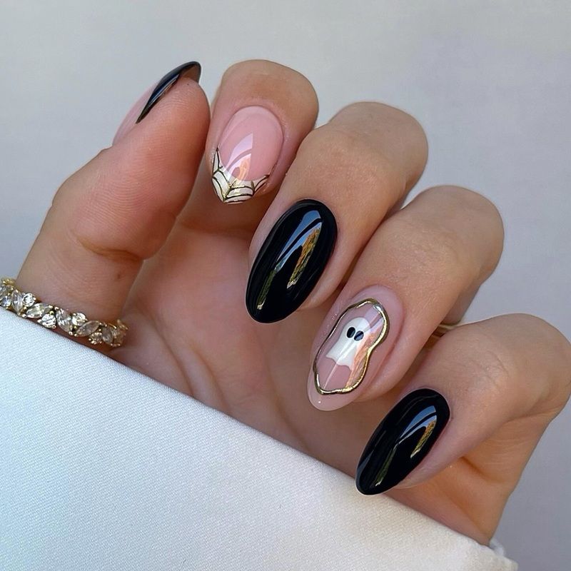A hand with stylish black and pink nail art.