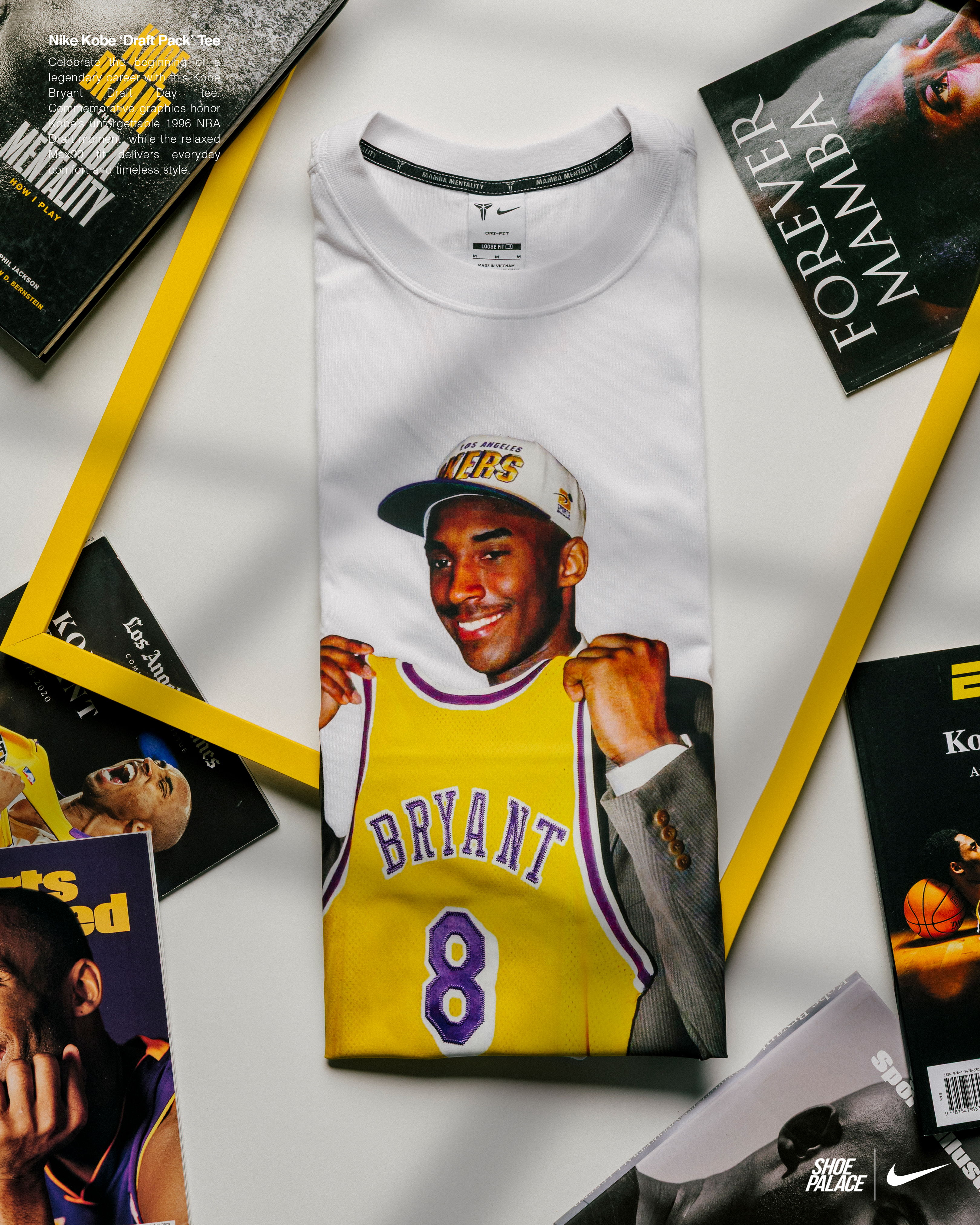 White t-shirt featuring a graphic of Kobe Bryant holding a Lakers jersey.