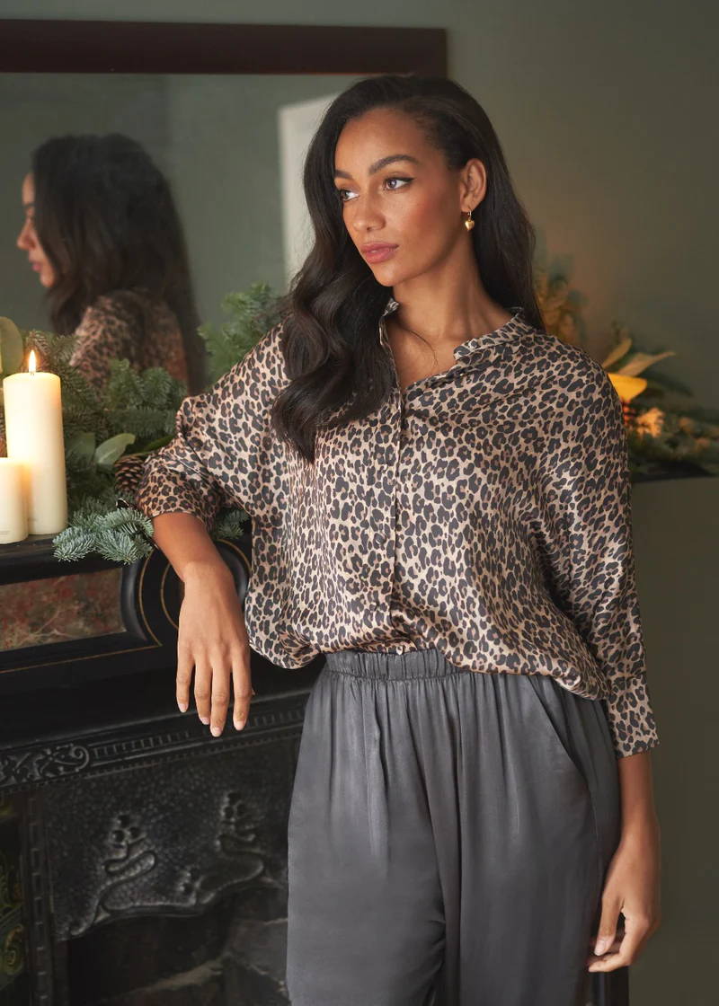 A model wearing a leopard print satin shirt with gret satin trousers