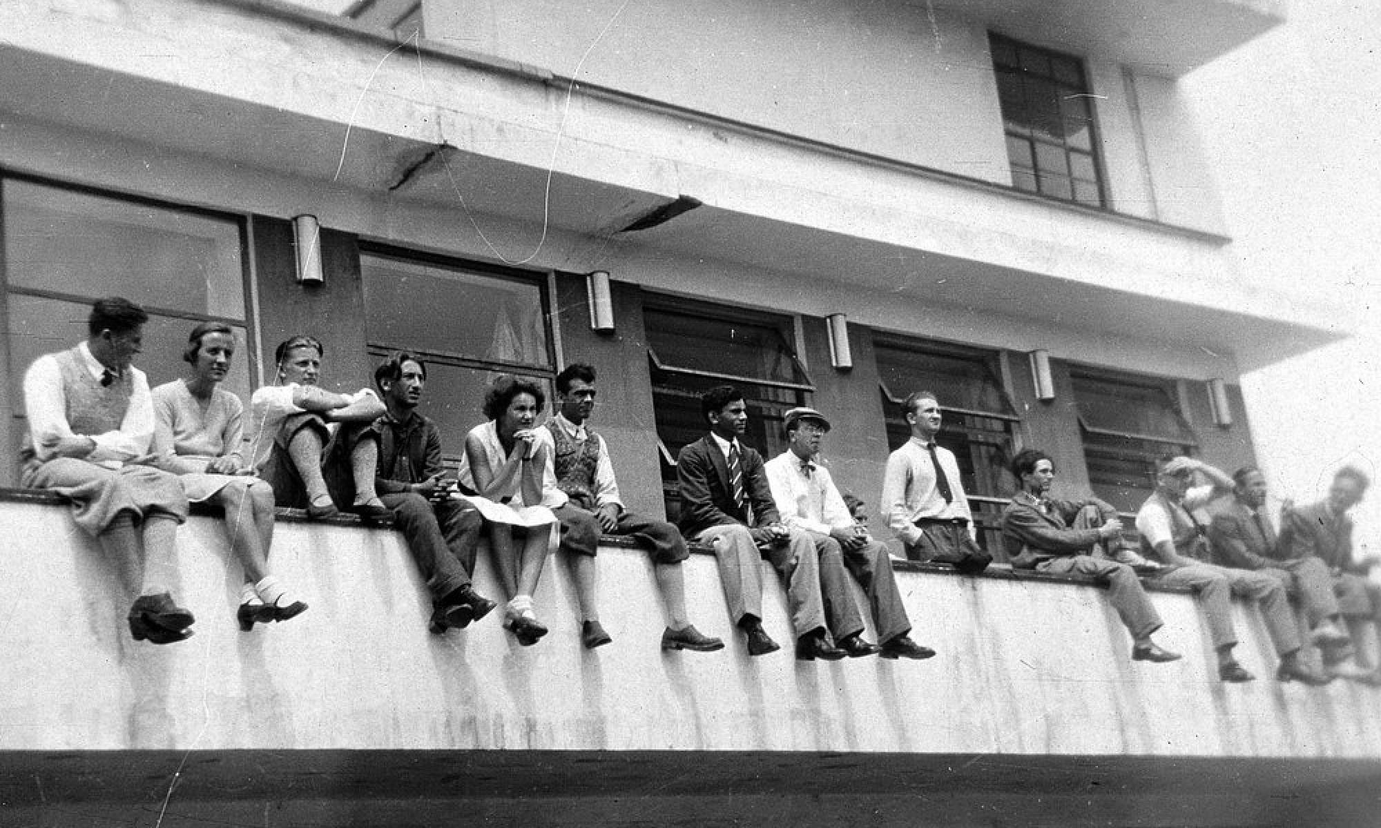Group of design students sitting on Bauhaus School balcony