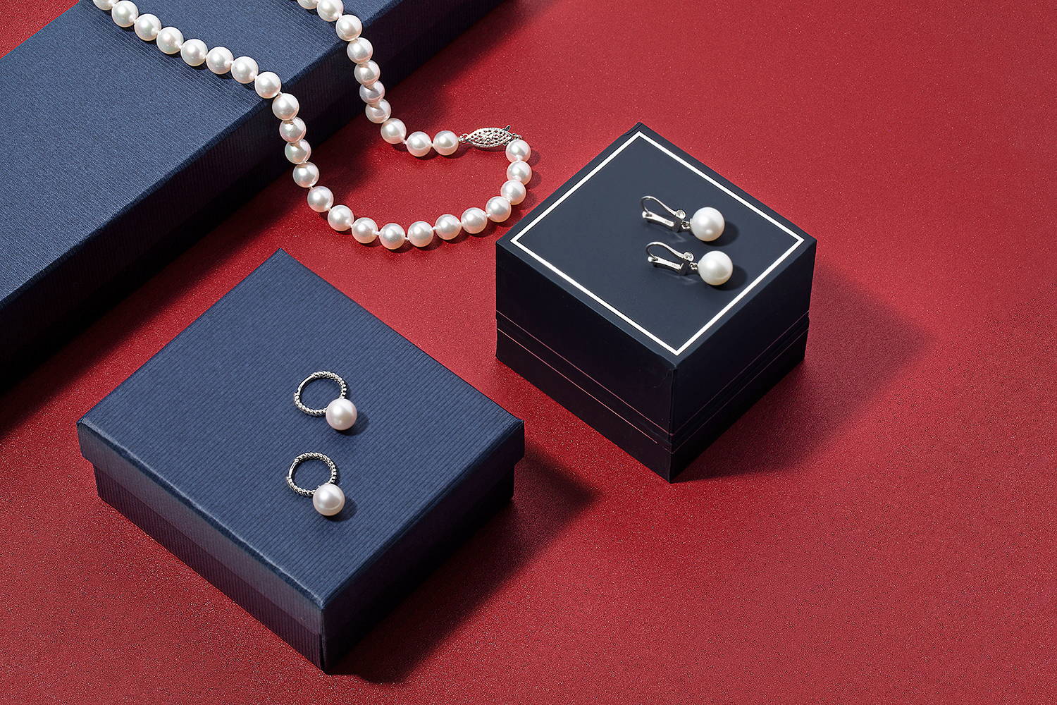 Pearl Necklaces and Earrings in Different Styles with Black Jewelry Boxes