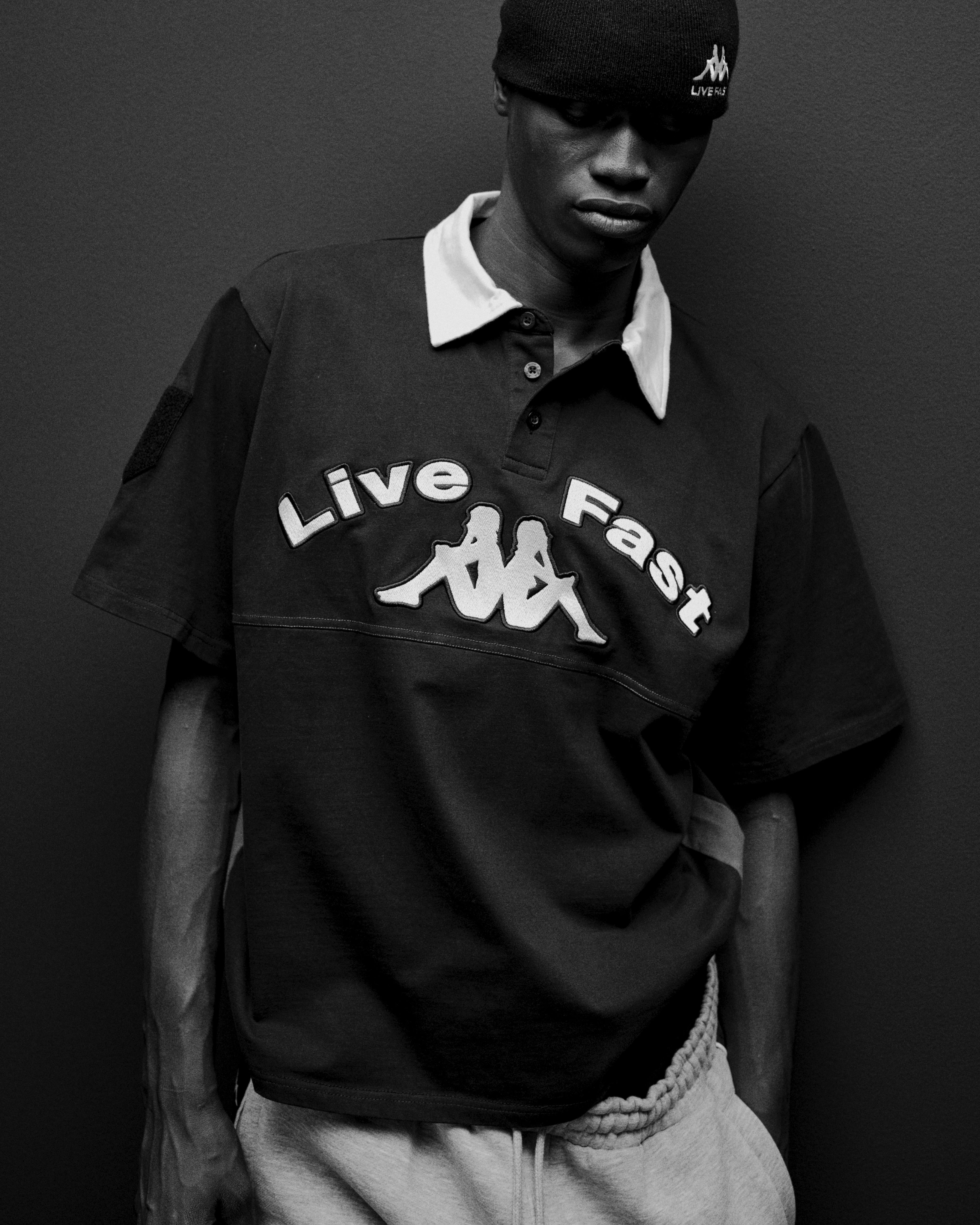 Male model wearing a black polo shirt with 