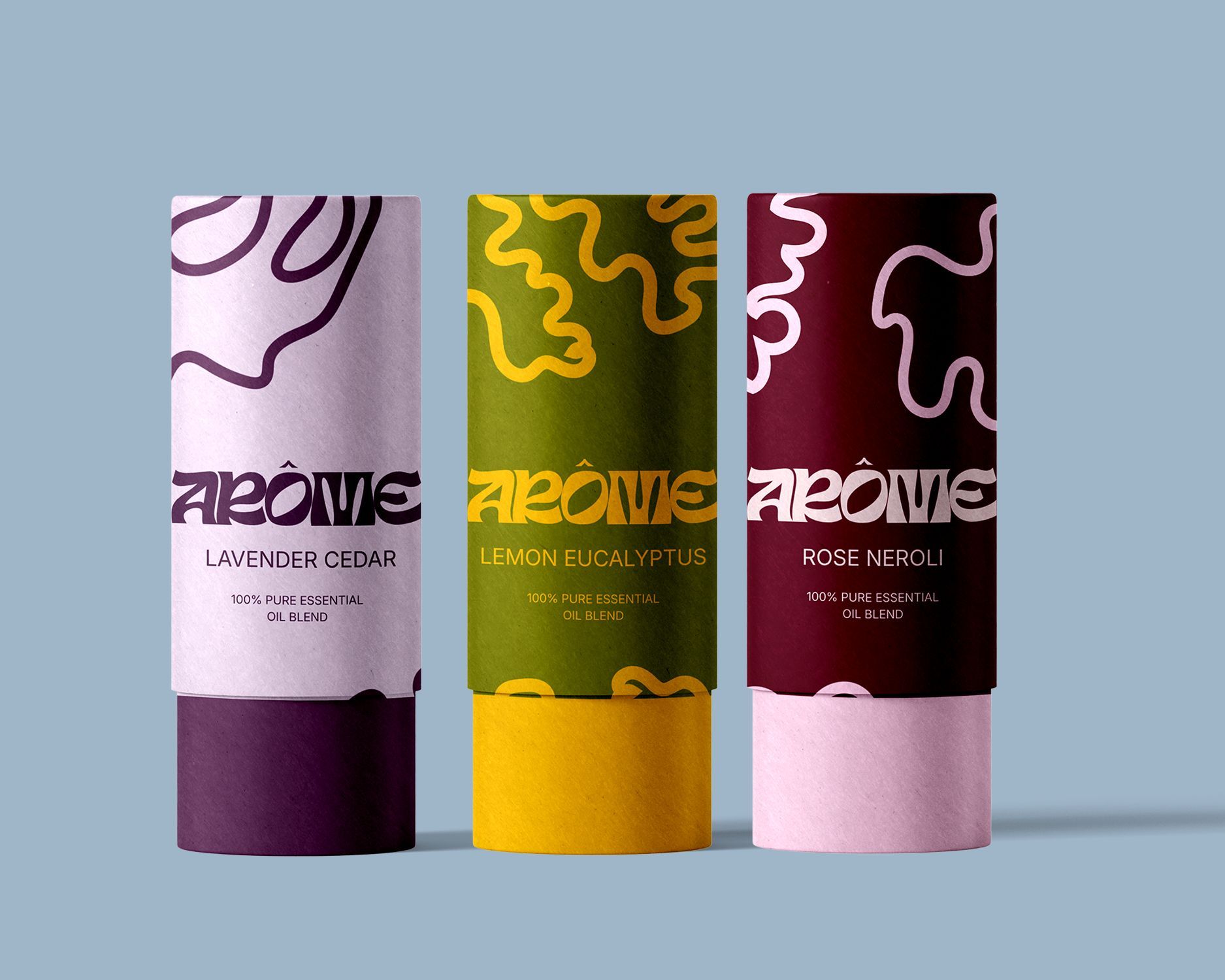 Three colorful essential oil paper tubes against a light blue background.