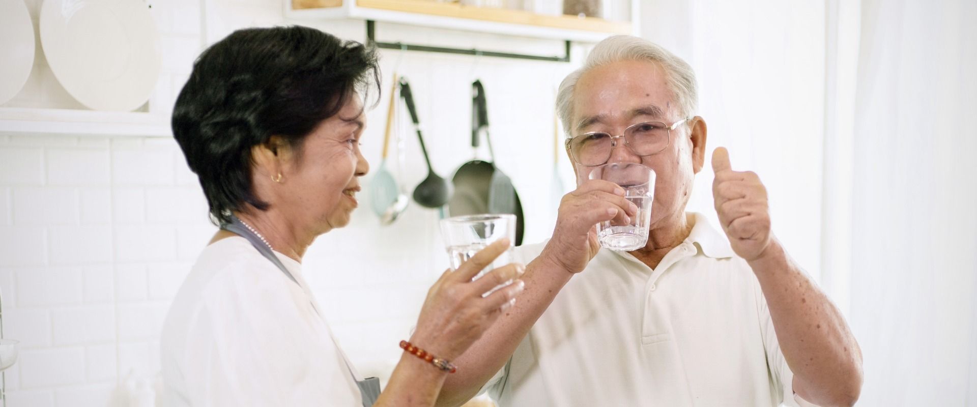 Older couple drinking glass of water
