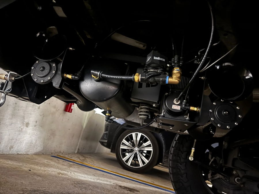 Close-up black stealth horn bells mounting bracket Stephen's Gladiator Stealth Spare Tire Delete install detail photo 6