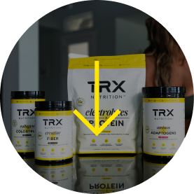 TRX Nutrition products displayed on a reflective surface.