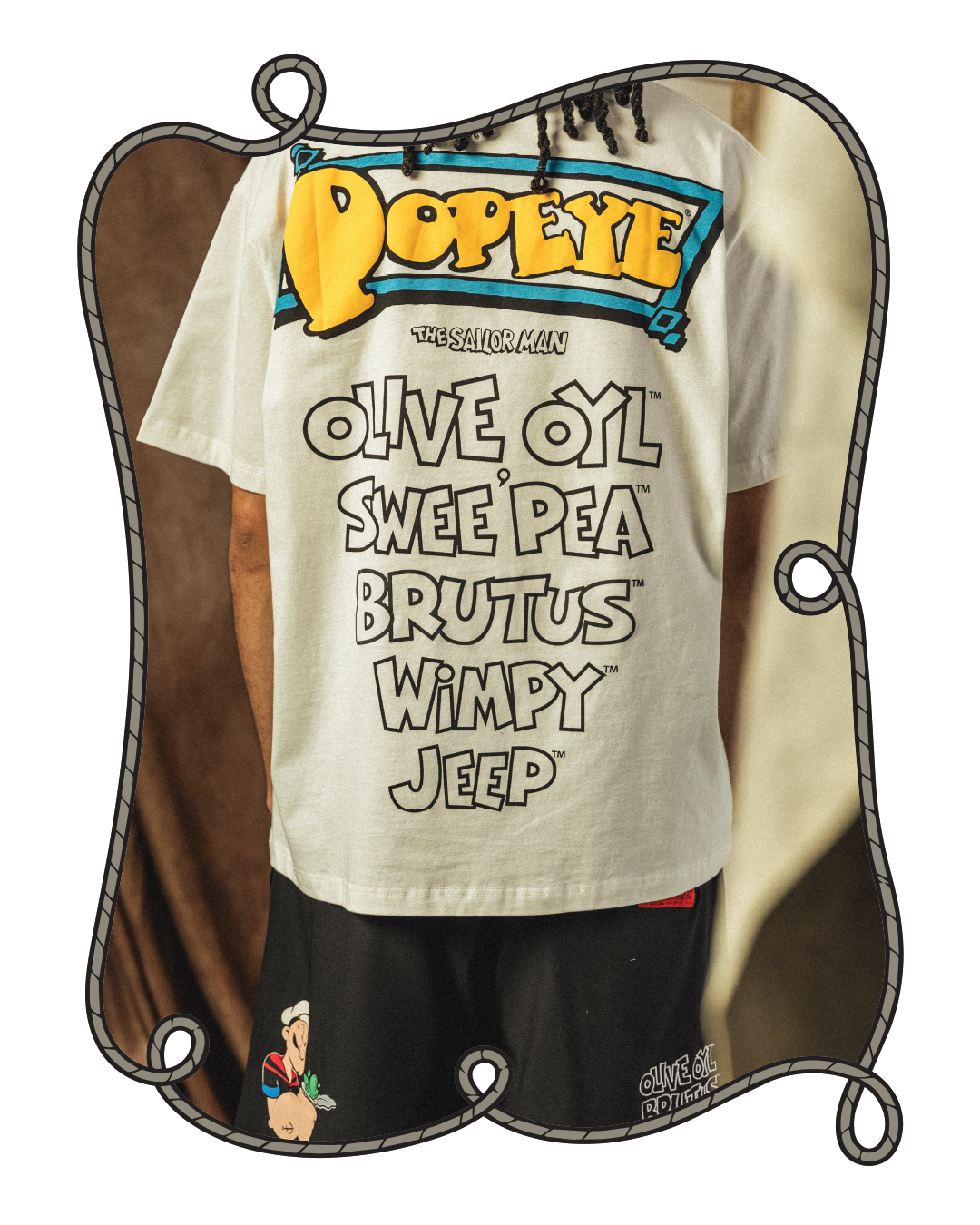 Person wearing a Popeye-themed shirt with character names listed.